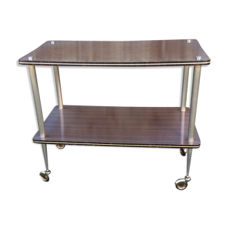 Vintage dessert table with wheels in brown Formica metal base.