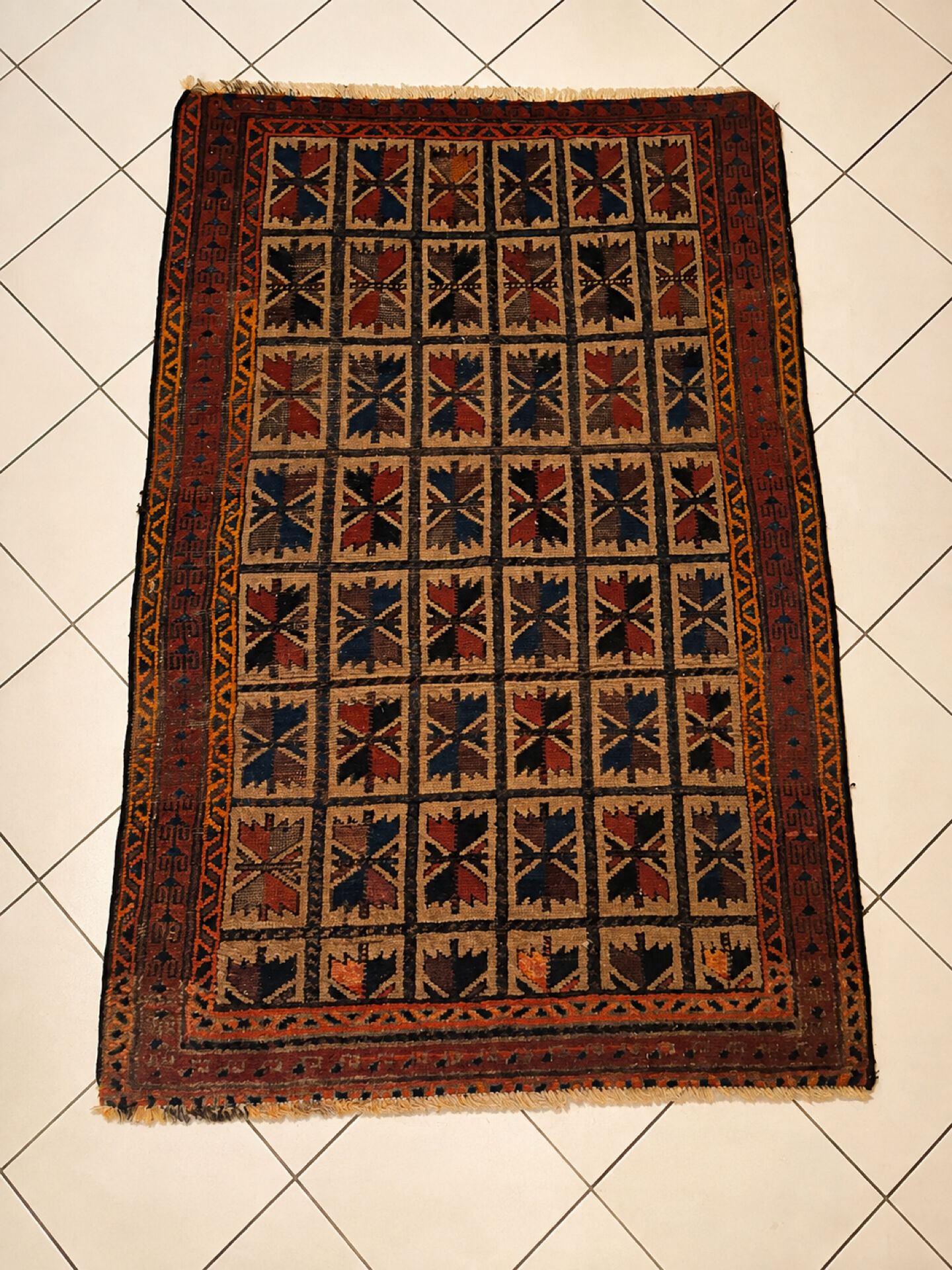Persian carpet, hand-knotted, geometric design.
