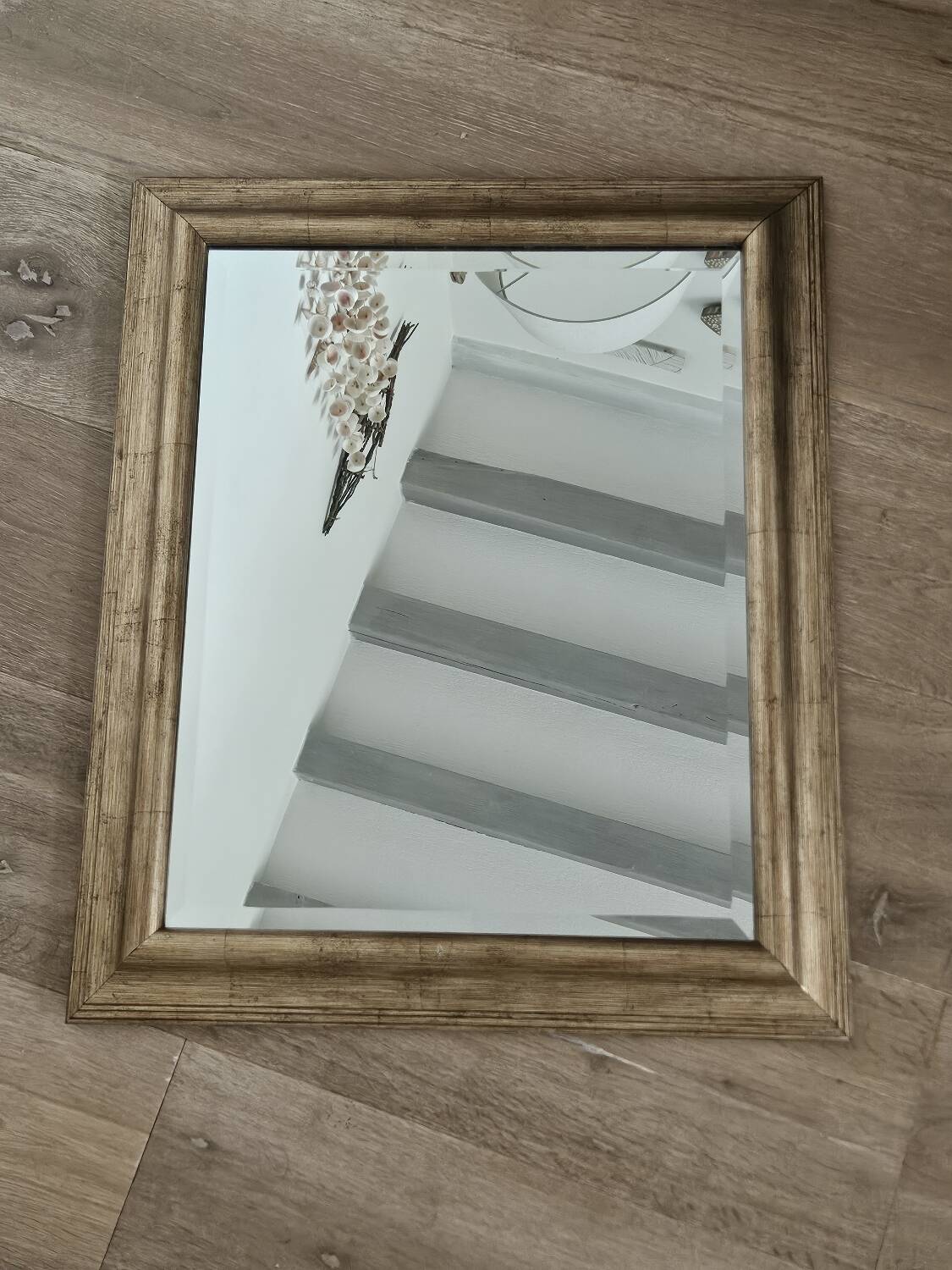 Beveled mirror under gold frame