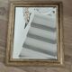 Beveled mirror under gold frame
