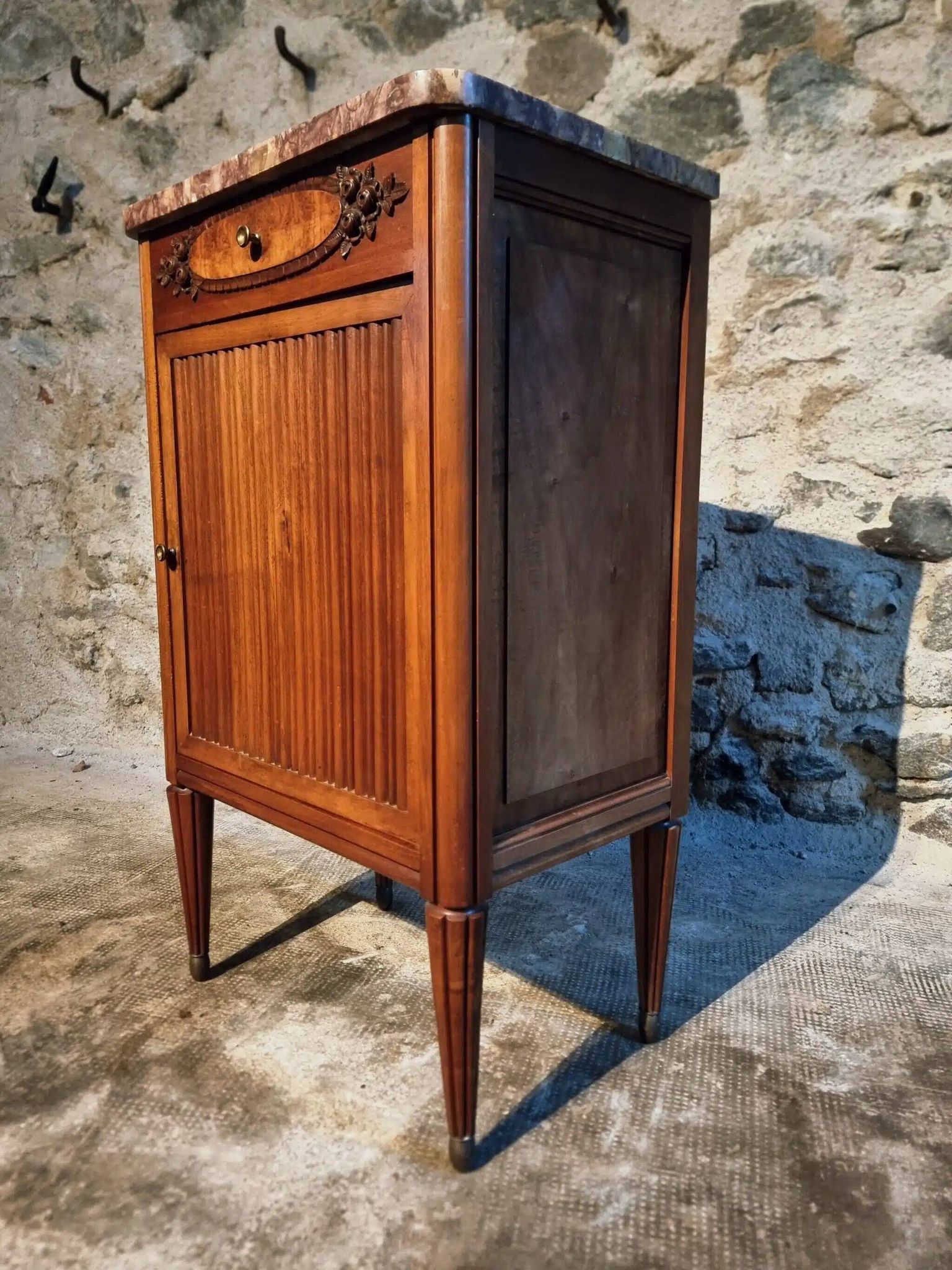 French antique bedside table in walnut with a marble top and porcelain interior, early 20th century.