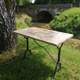 Inlaid bistro table with cases of wine.
