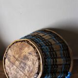 Vintage wooden basket with round handle, blue and black weaving.