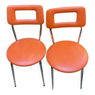 Two orange 70 chairs