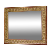 Large beveled mirror with its golden frame.