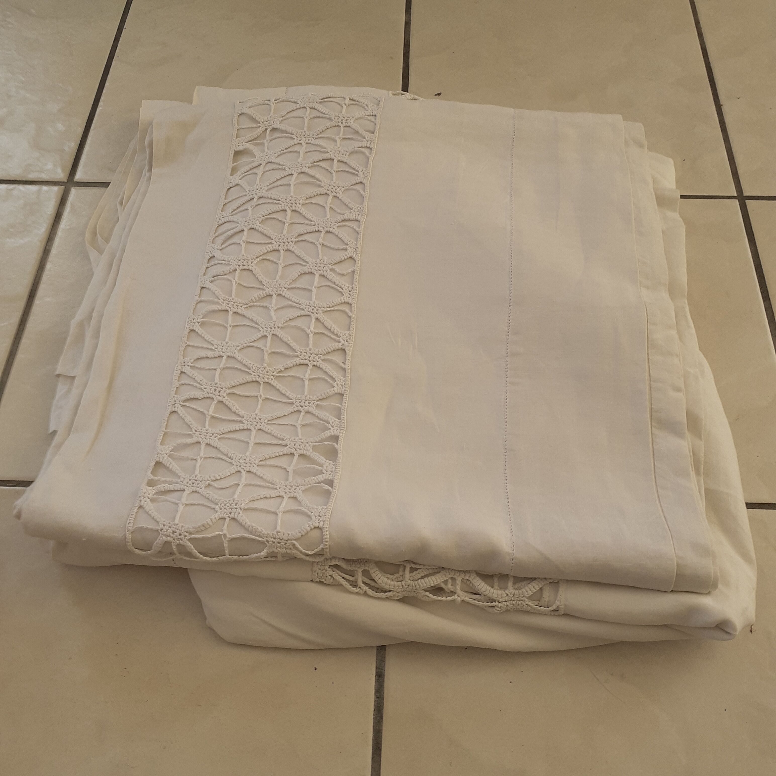 Pair of large thread sheets with handmade lace between two.