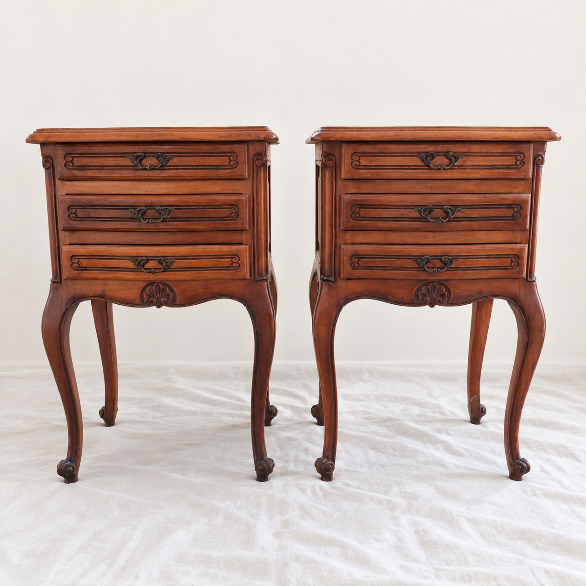 Pair of cherry wood bedside tables in Louis XV style with 3 drawers.