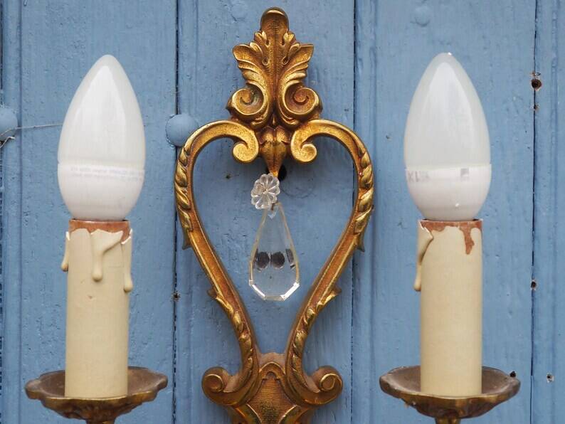 French antique Louis XV style twin arm wall sconces in bronze with crystals.