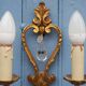 French antique Louis XV style twin arm wall sconces in bronze with crystals.