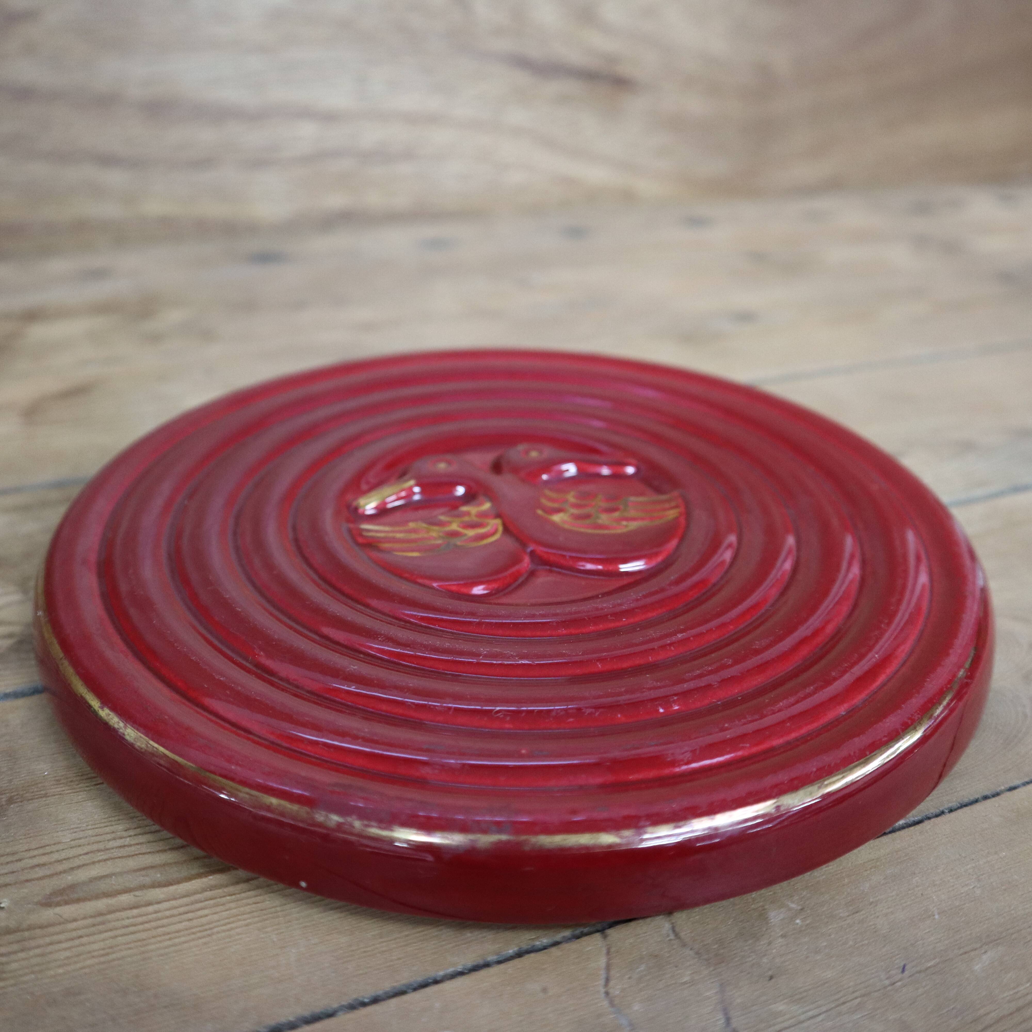 Vintage burgundy duck trivet with gold edging