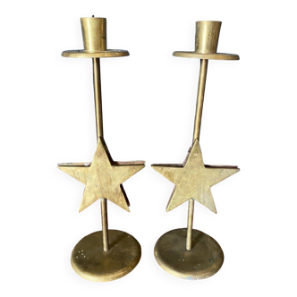 Pair of brass candlesticks decorated with 20th century stars
