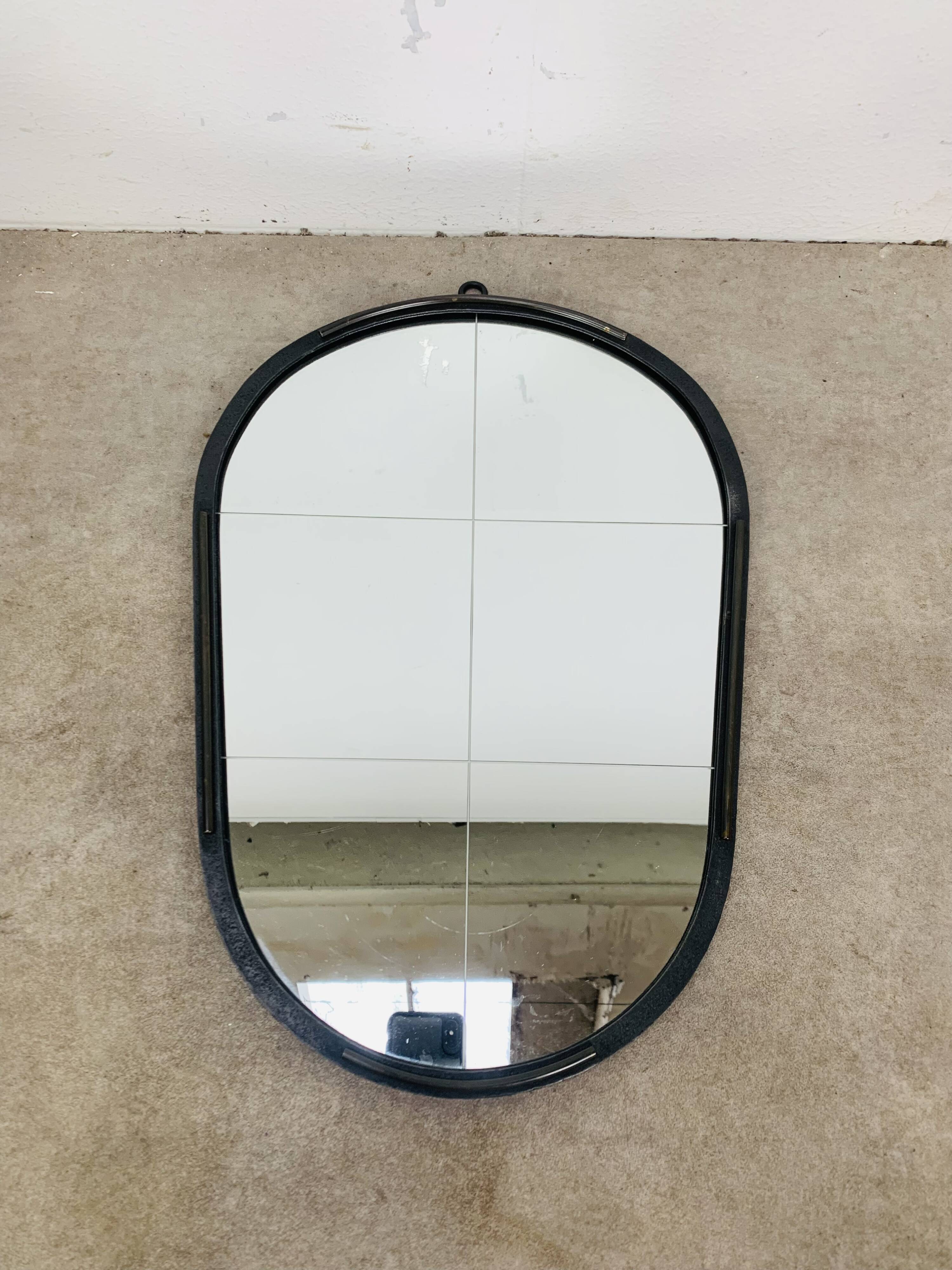 Oval mirror from the 1950s, wrought iron and brass.