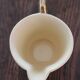 Ecru ceramic milk jug with gold decoration from Sarreguemines.