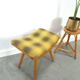 Vintage footrest with checkered cushion