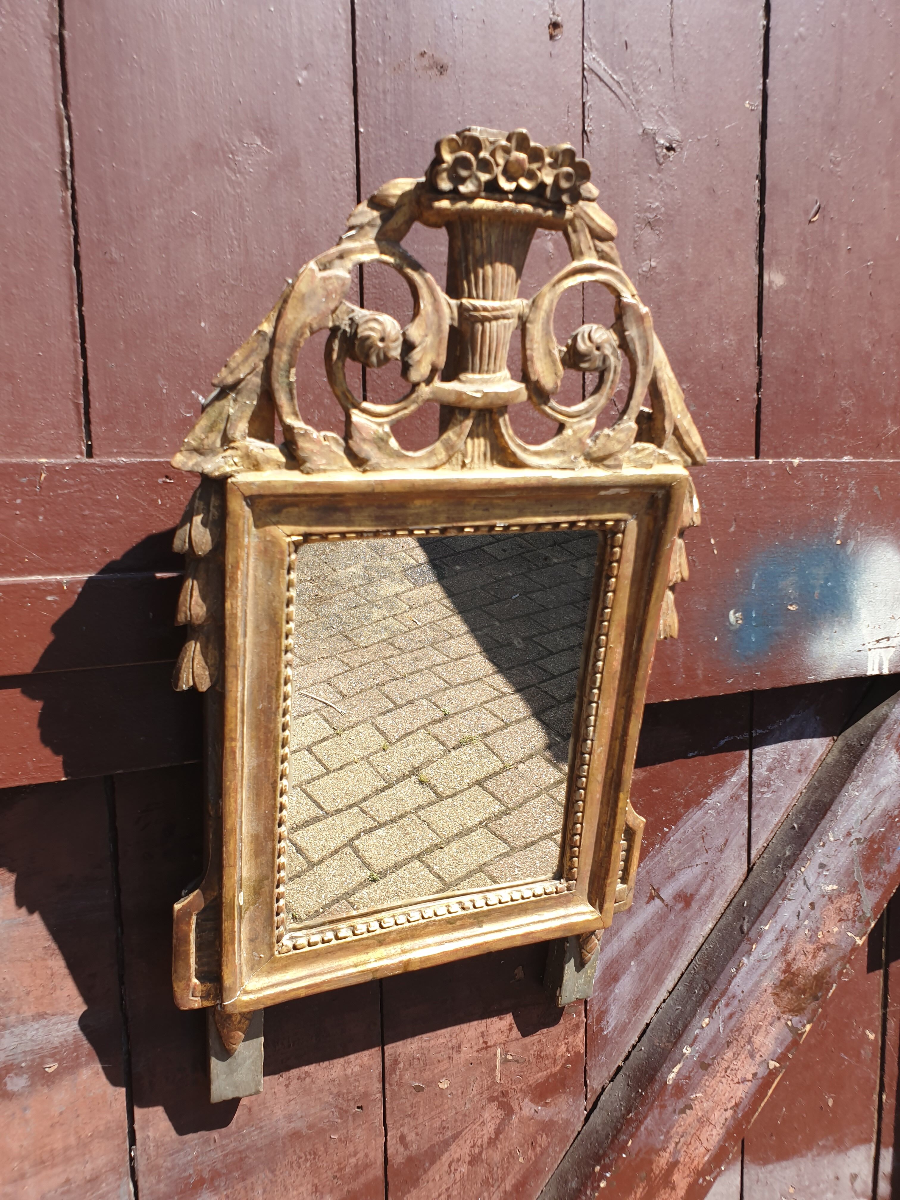 Old mirror in carved and gilded wood