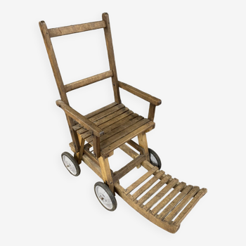 Chaise roulante en lattes de bois ancien avec repose-pieds extensible