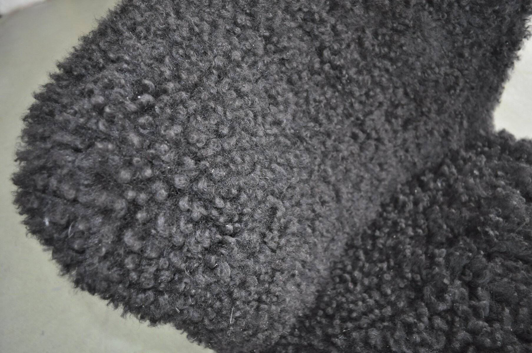 Mid-century black cocktail chair in lambskin, beech legs — 1960s