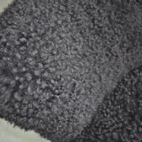 Mid-century black cocktail chair in lambskin, beech legs — 1960s