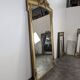 Large gilded wooden mirror in Louis XVI style from the late 19th century.