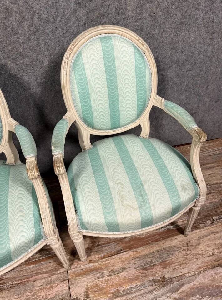 Pair of Louis XVI cabriolet armchairs in lacquered wood, 18th century