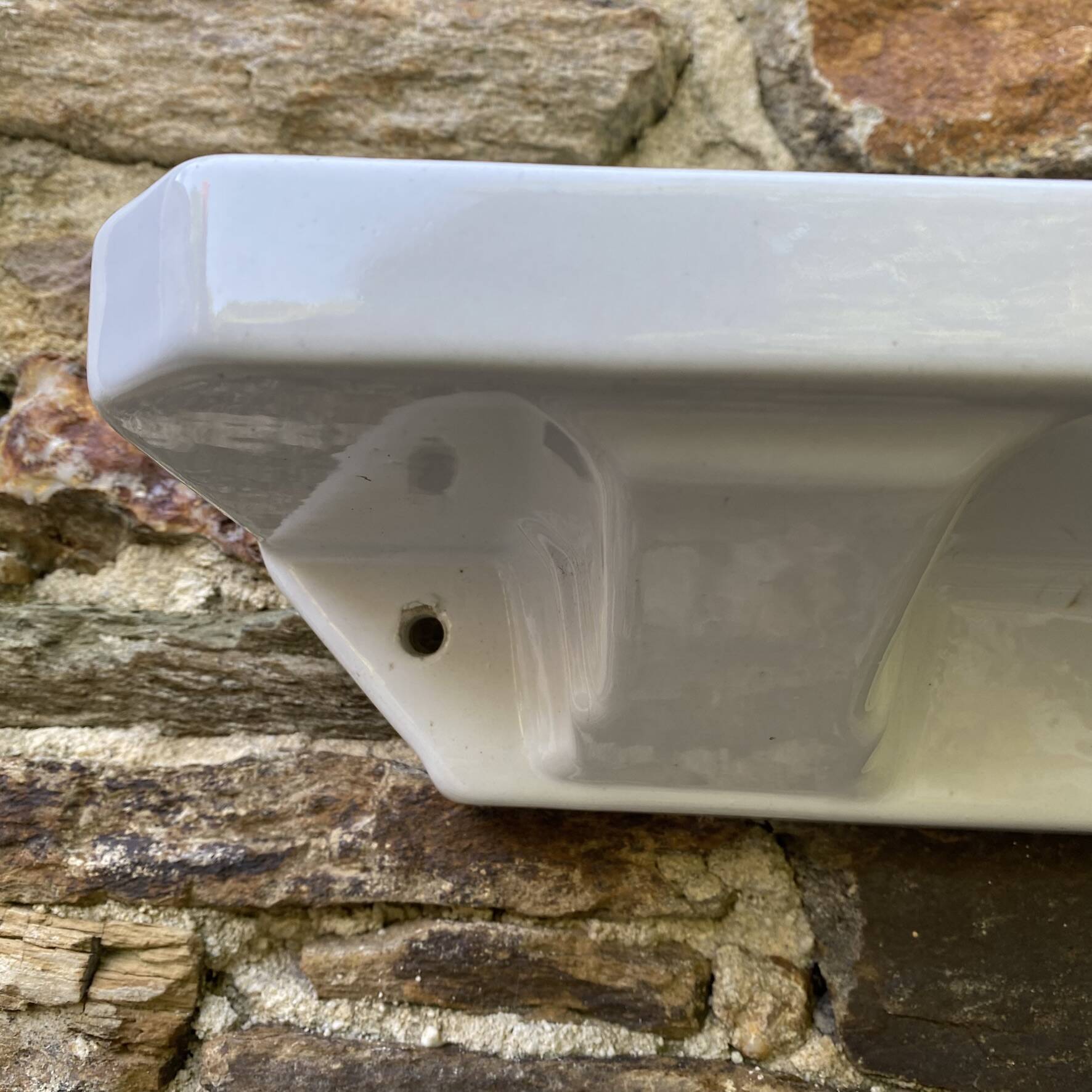 Antique wall shelf for bathroom in white porcelain.