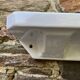 Antique wall shelf for bathroom in white porcelain.