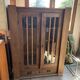 Antique display cabinet in brown oak with glass doors and a drawer, 1890-1919.