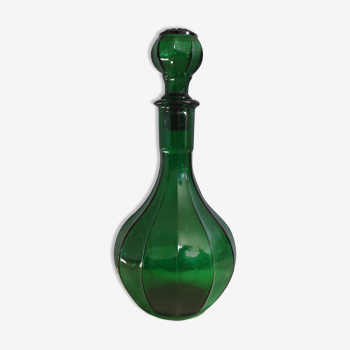 Old green carafe with ribbed lines