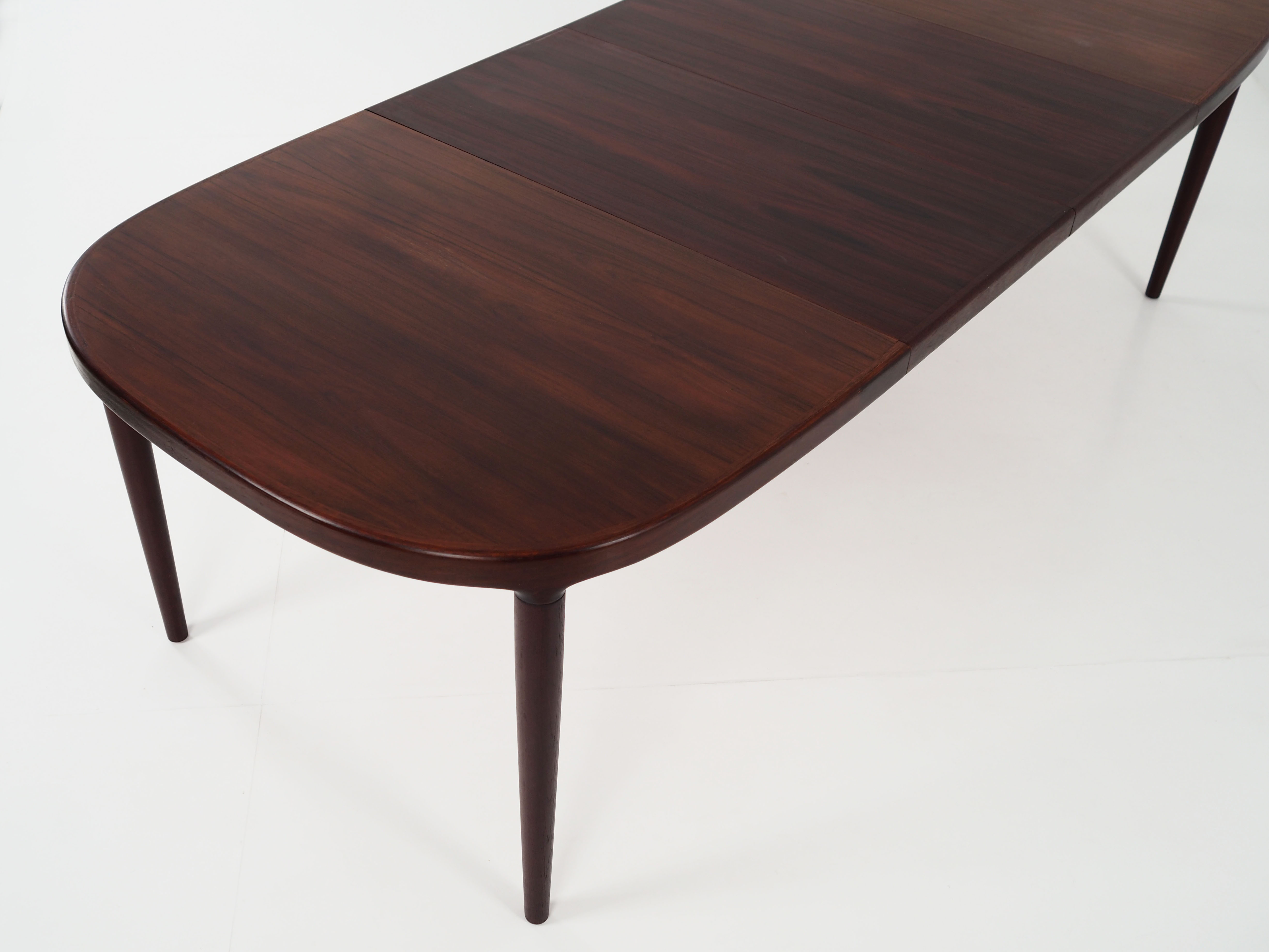 Oval table, covered with rosewood veneer.Design of the 70s