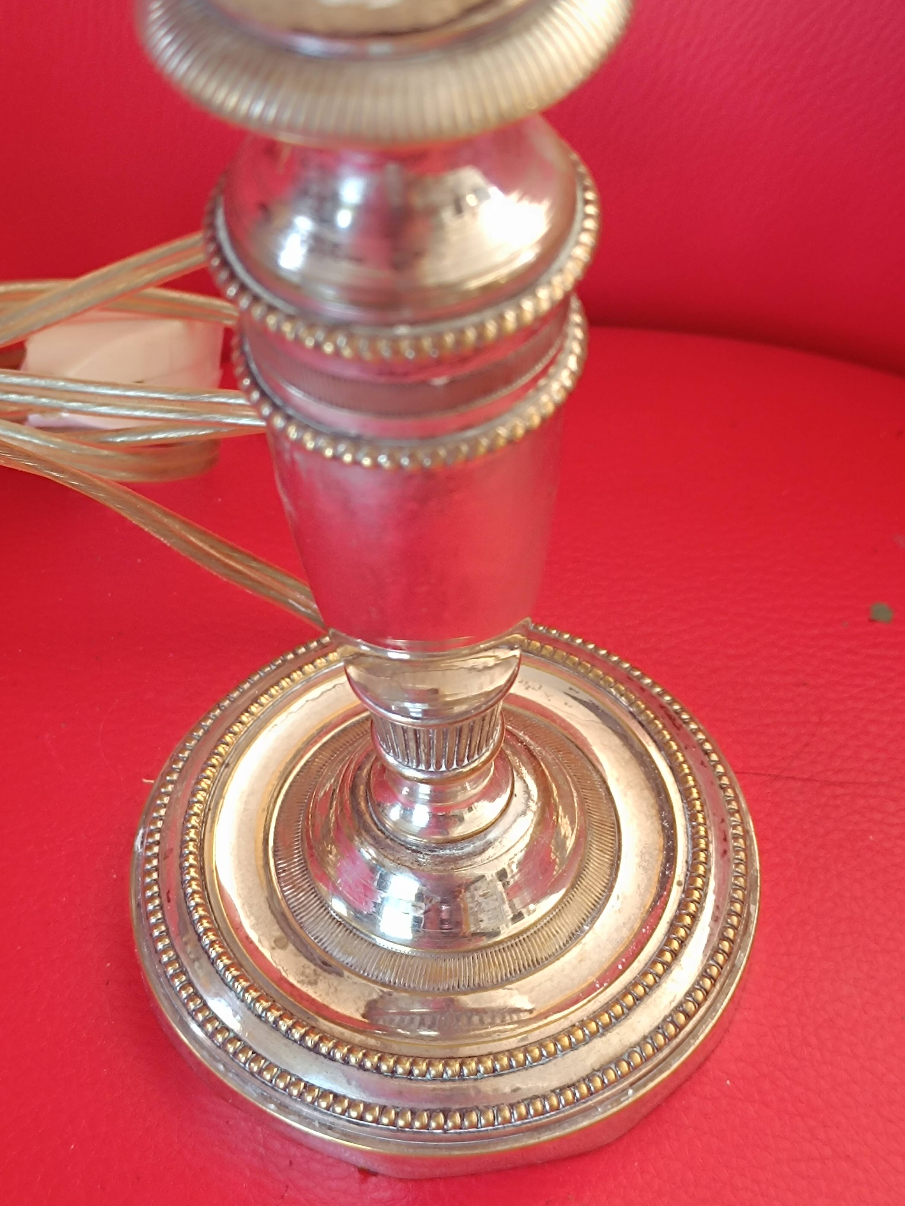 Old lamp base in silver metal.