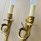 Bronze wall lights in the Louis XV style with curved branches and leaf decorations.