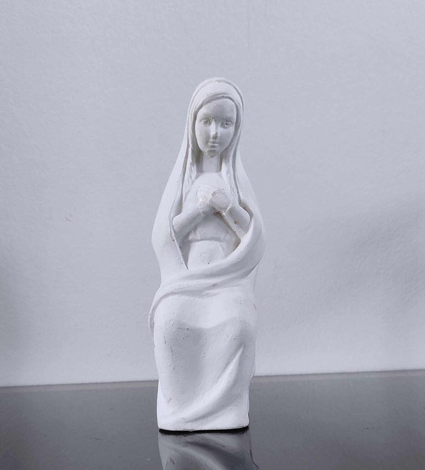 Vintage white plaster statuette of the Virgin Mary.