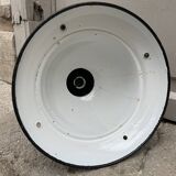 Black industrial pendant light in enameled sheet metal