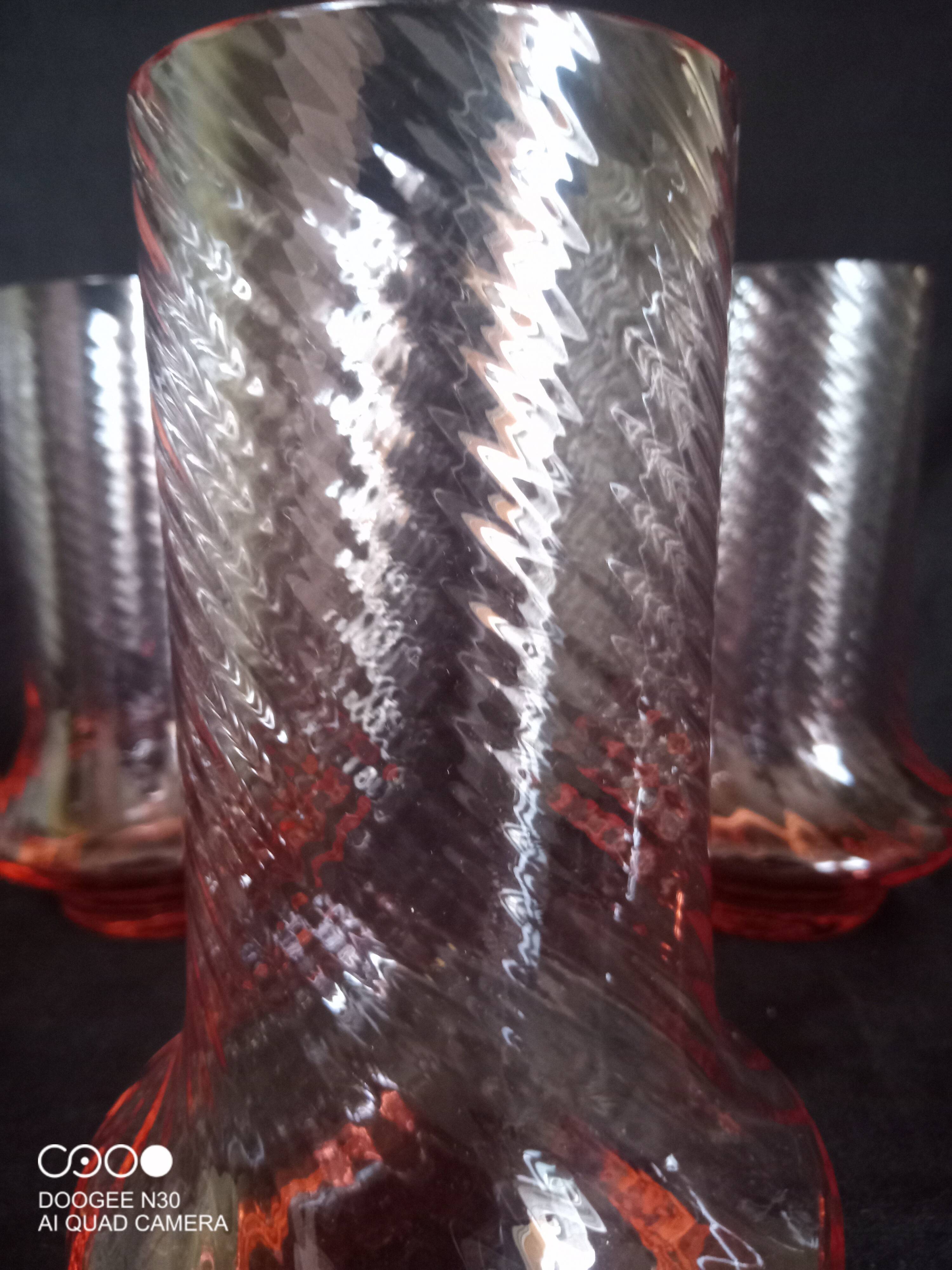 Art Deco orangeade service in pink-orange glass, twisted model.