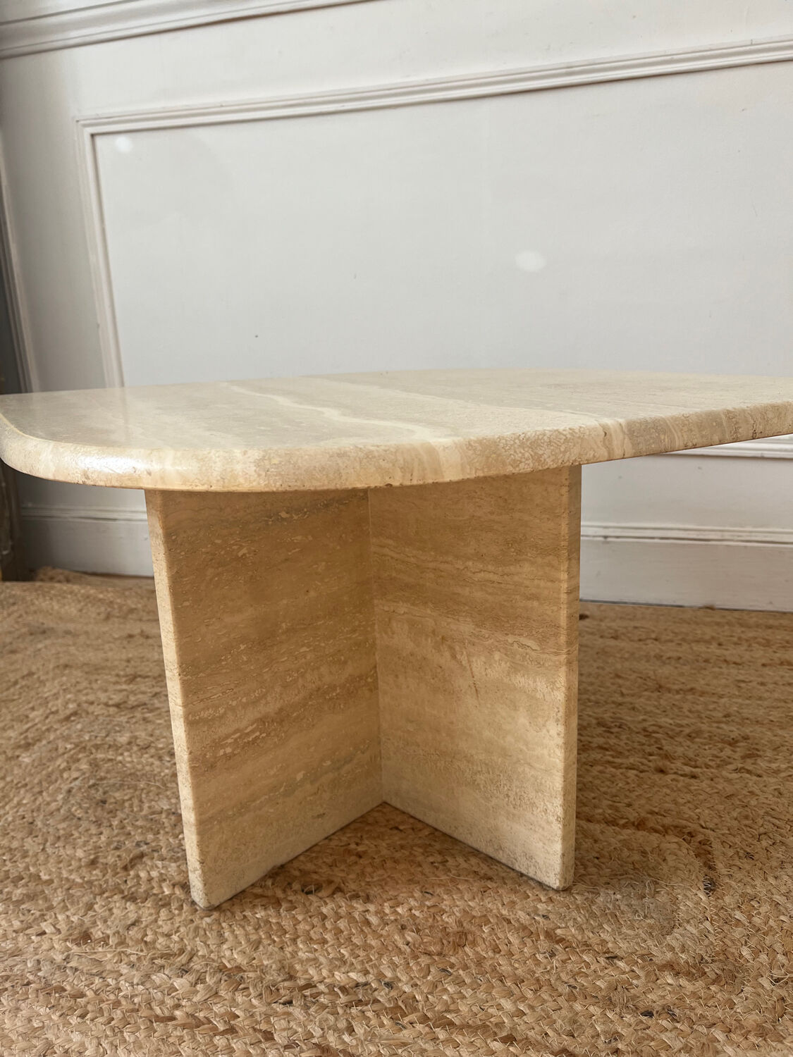 Travertine coffee table in eye shape.