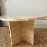 Travertine coffee table in eye shape.
