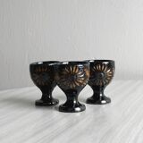 3 black ceramic egg cups with floral patterns