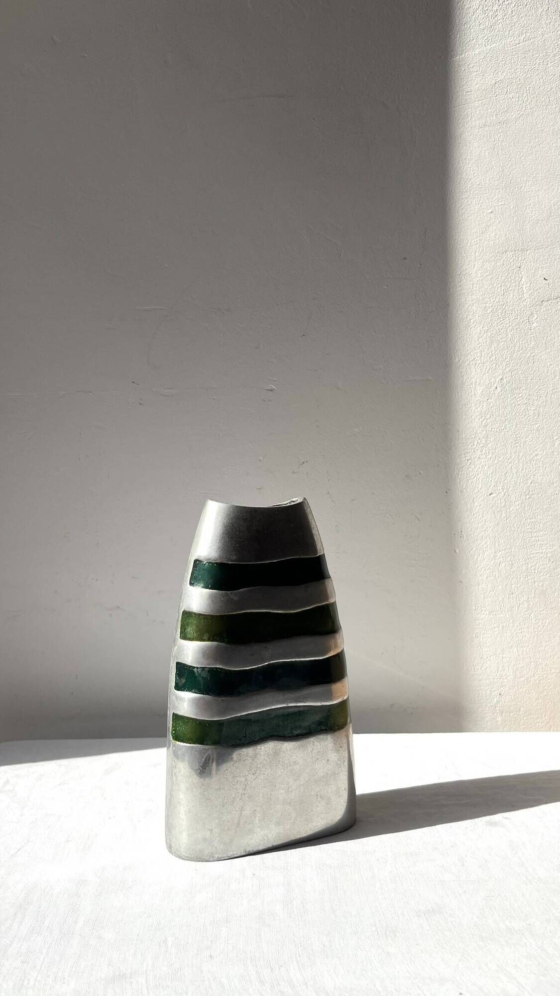Vintage brushed aluminium vase with green stripes.