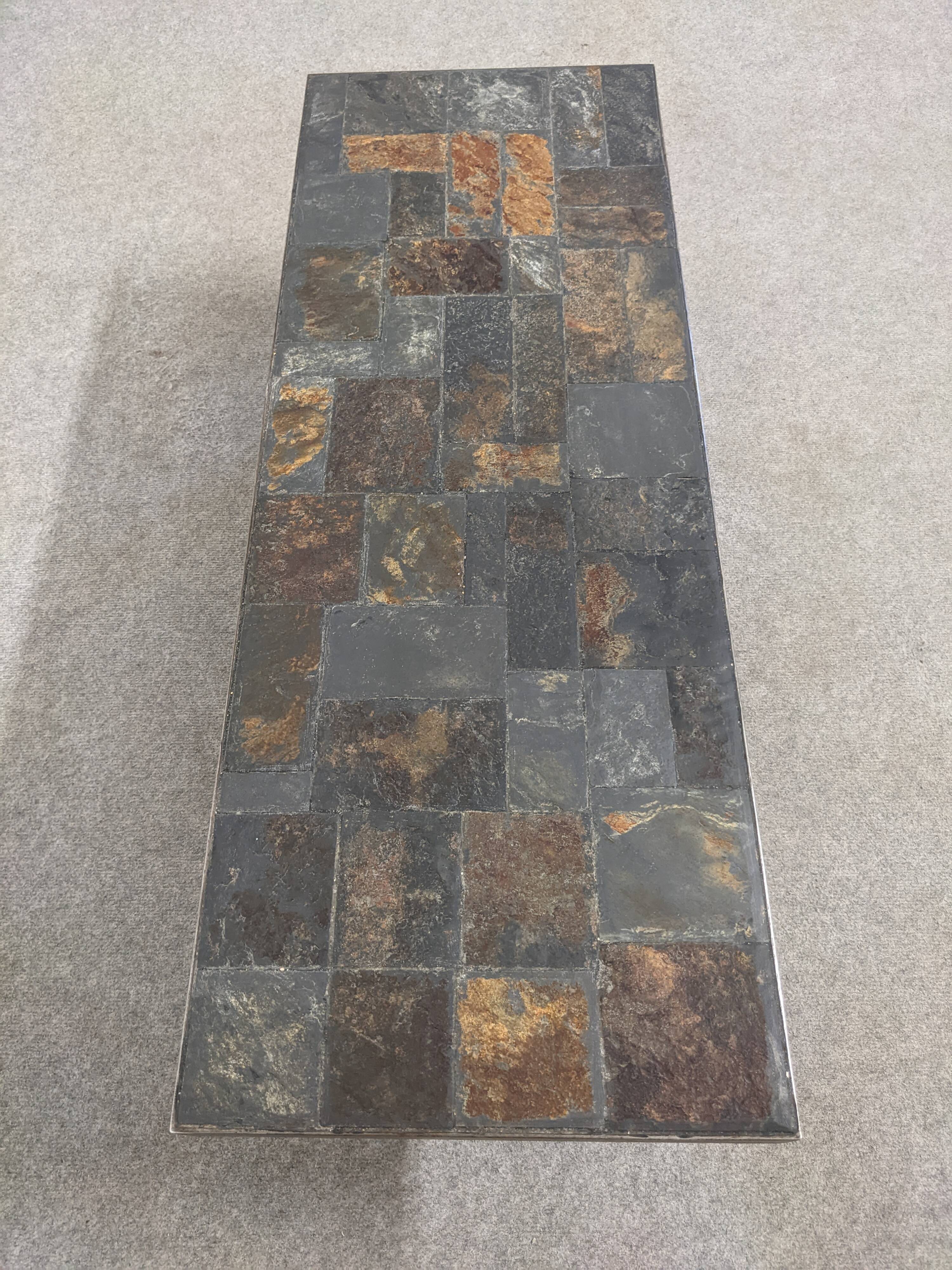 Brutalist coffee table in natural stone and wrought iron, France circa 1960.