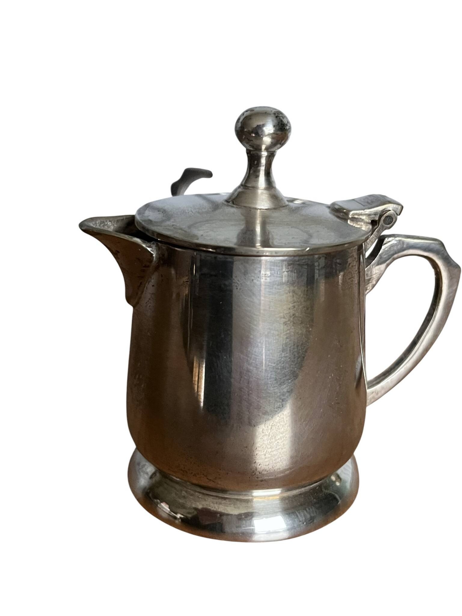 Two small silver-plated metal tea service pots from the 20th century.