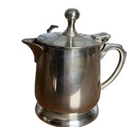 Two small silver-plated metal tea service pots from the 20th century.