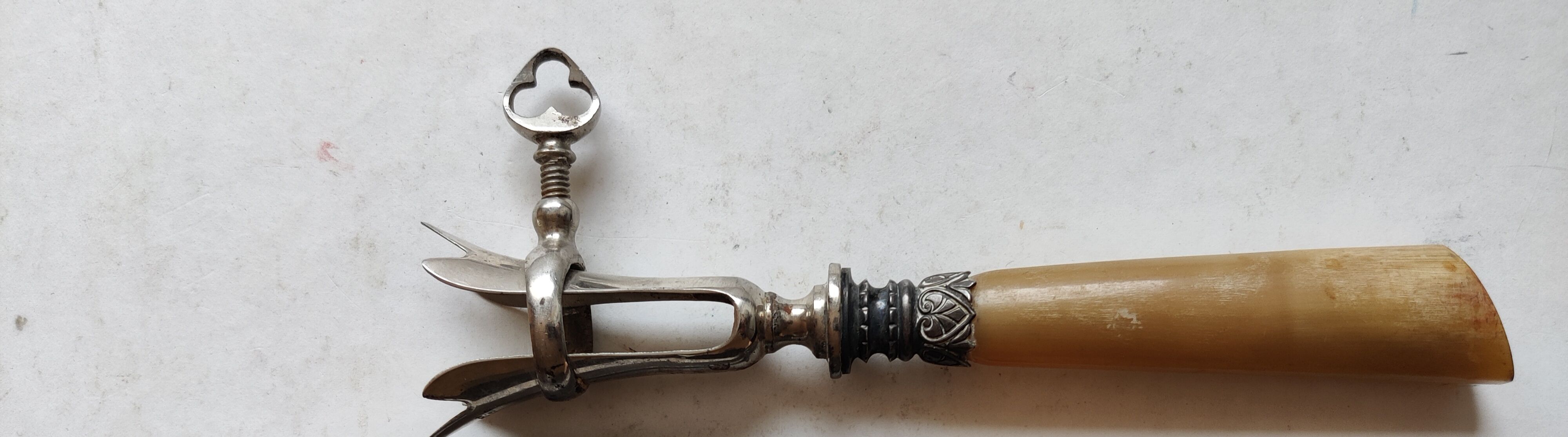 Horn and silver metal leg of lamb tong handle