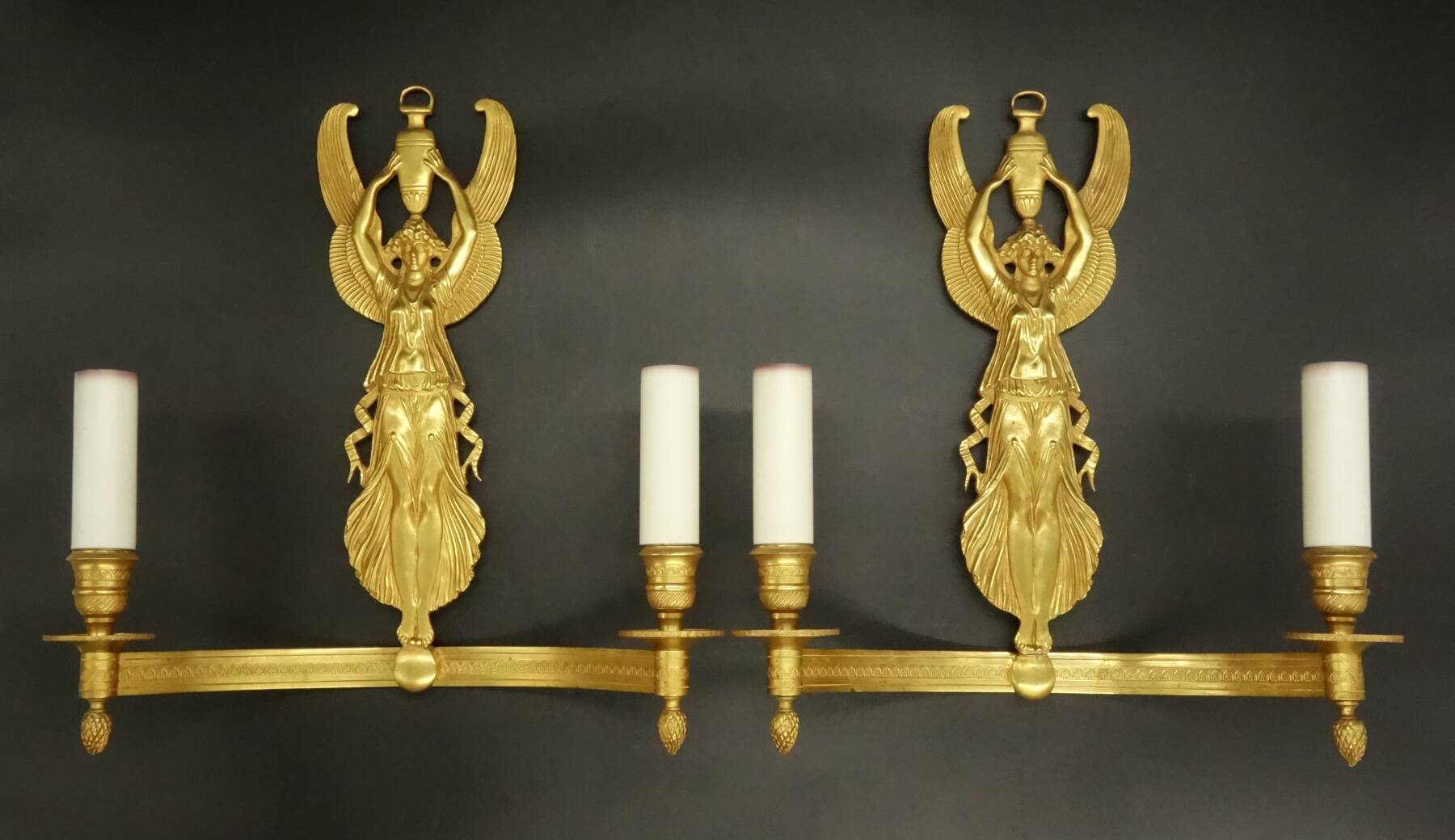 Large pair of wall sconces with winged caryatids in Empire style - gilded bronze