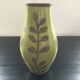 Large green vase with floral decoration