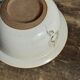 Small thick stoneware bowl with a stylised flower pattern in white on the outside, b