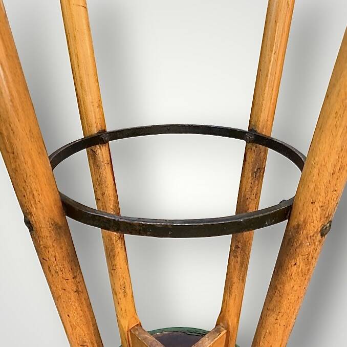 Old solid wood bar stool, metal footrest, green leatherette seat