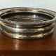 Antique silver-plated bottle coaster with floral decoration.