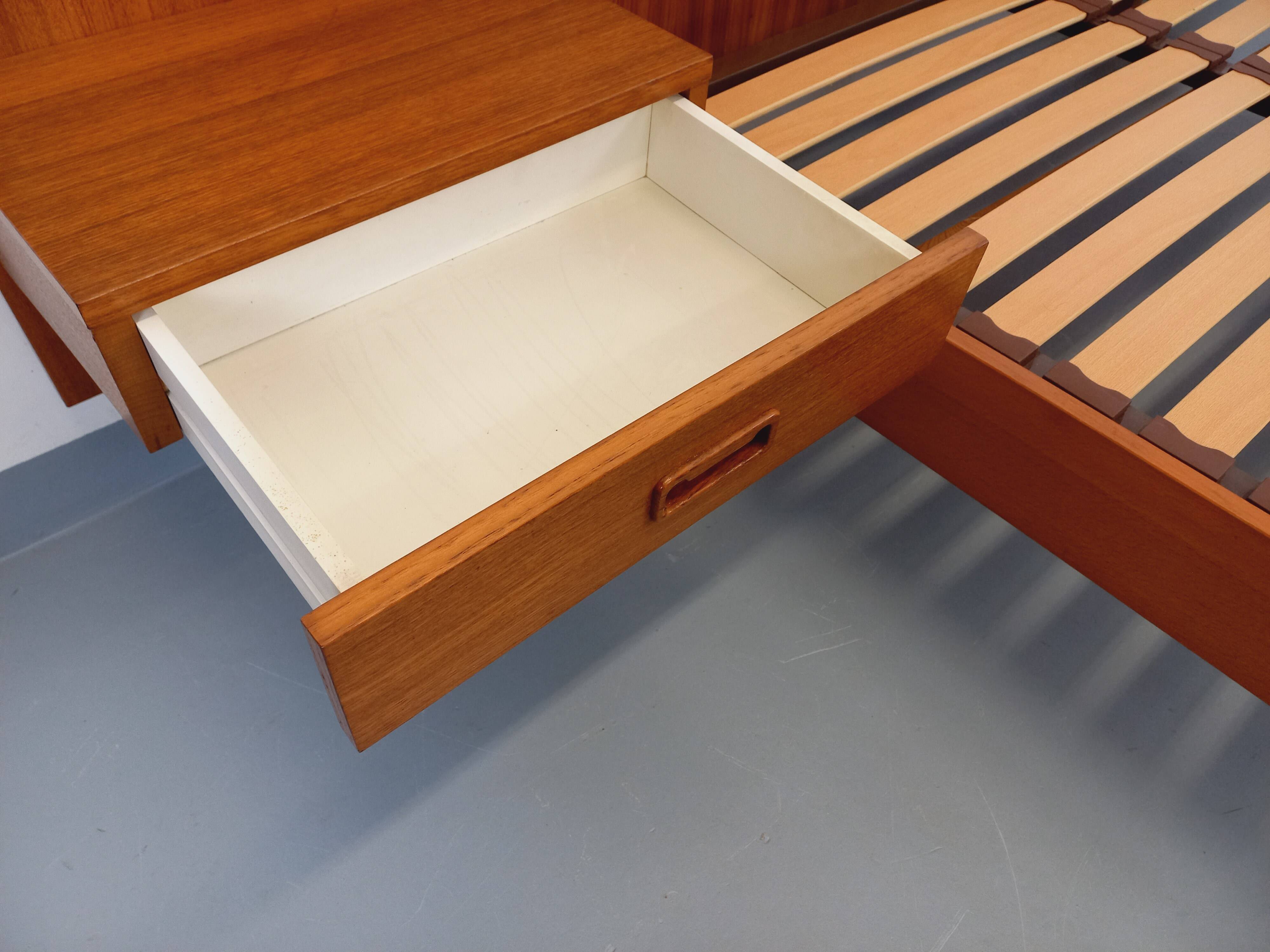 Double bed vintage Scandinavian in teak from the 1960s with integrated bedside tables.