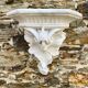 Antique wall console in patinated white plaster.