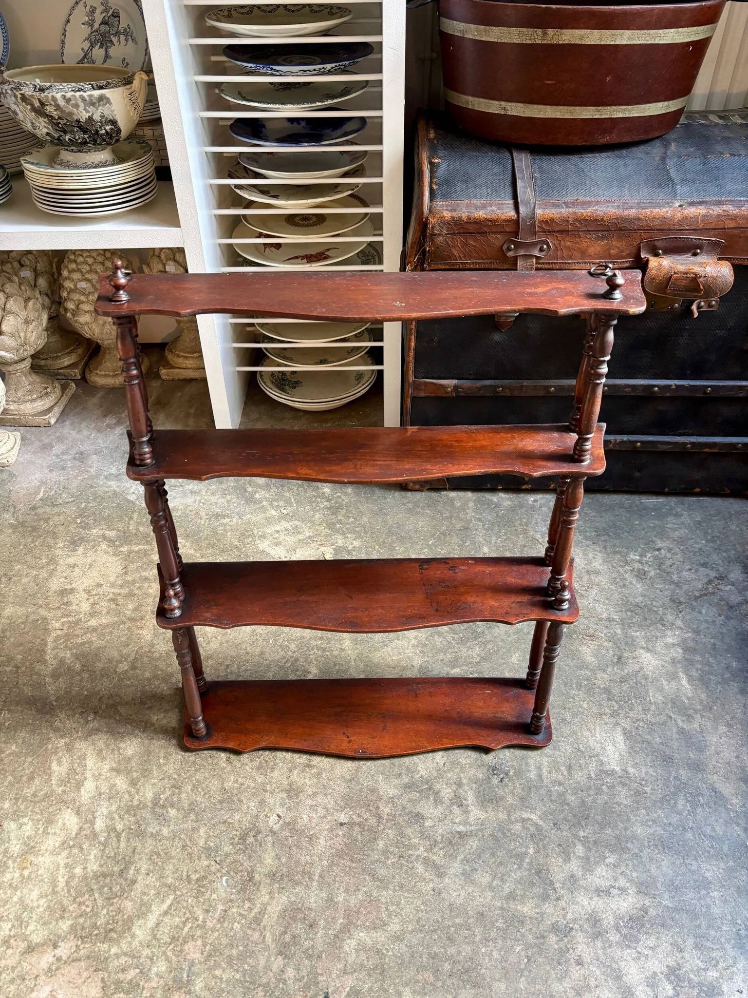 Curved and turned wooden wall shelf